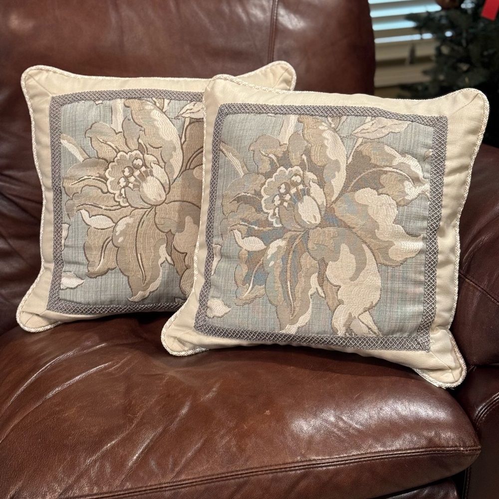 Floral accent pillows with gray/cream/blue hues.